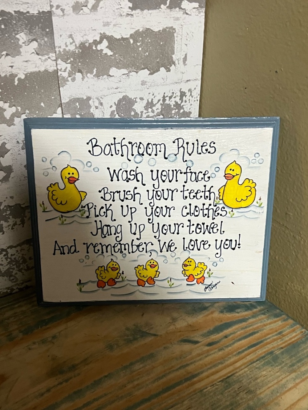 Handcrafted wooden "Bathroom Rules" sign featuring painted yellow duck